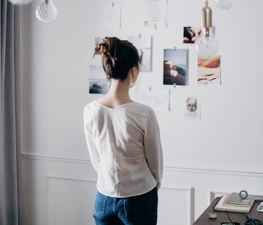 Woman staring at an art-gallery wall